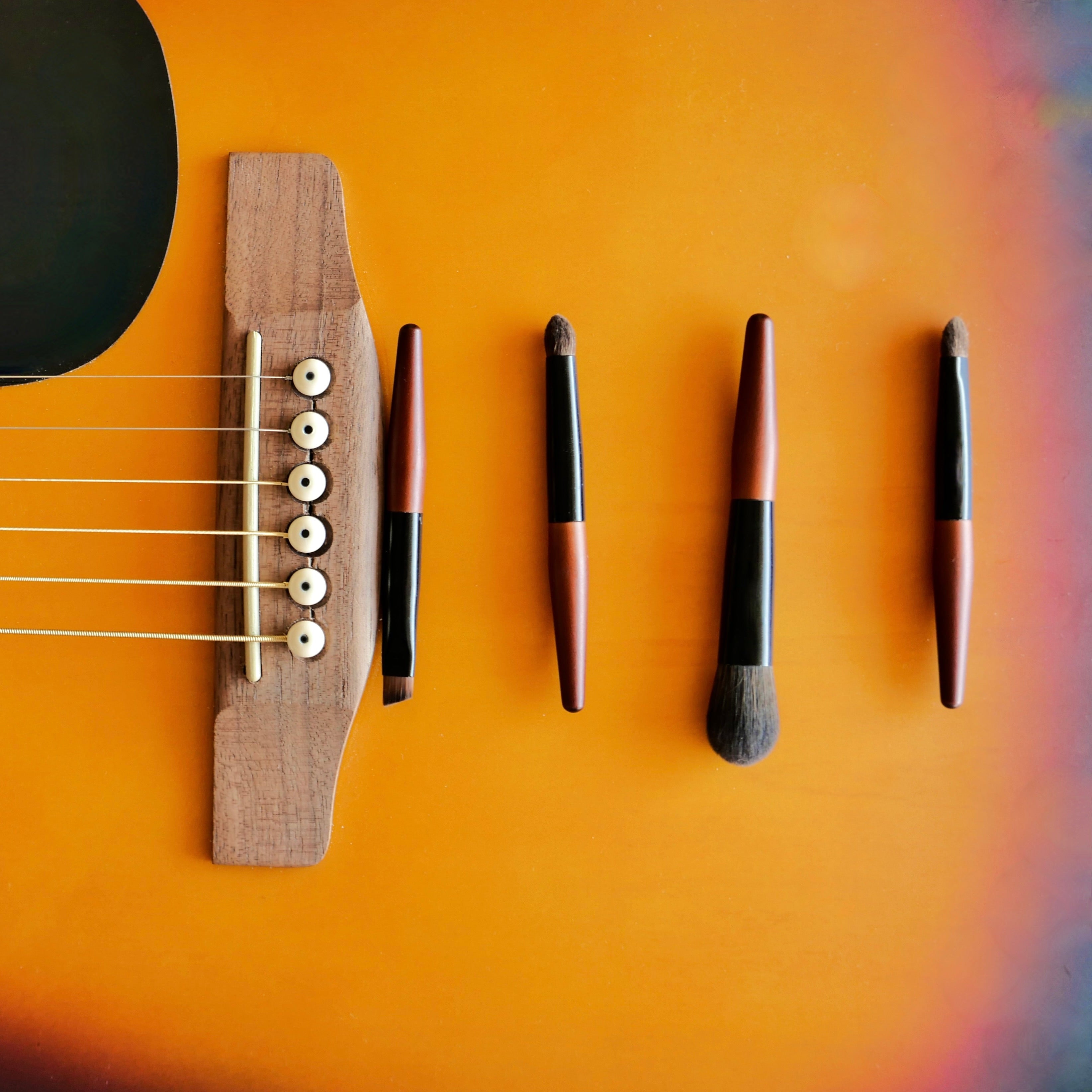 Mini Makeupbrushes on a guitar 