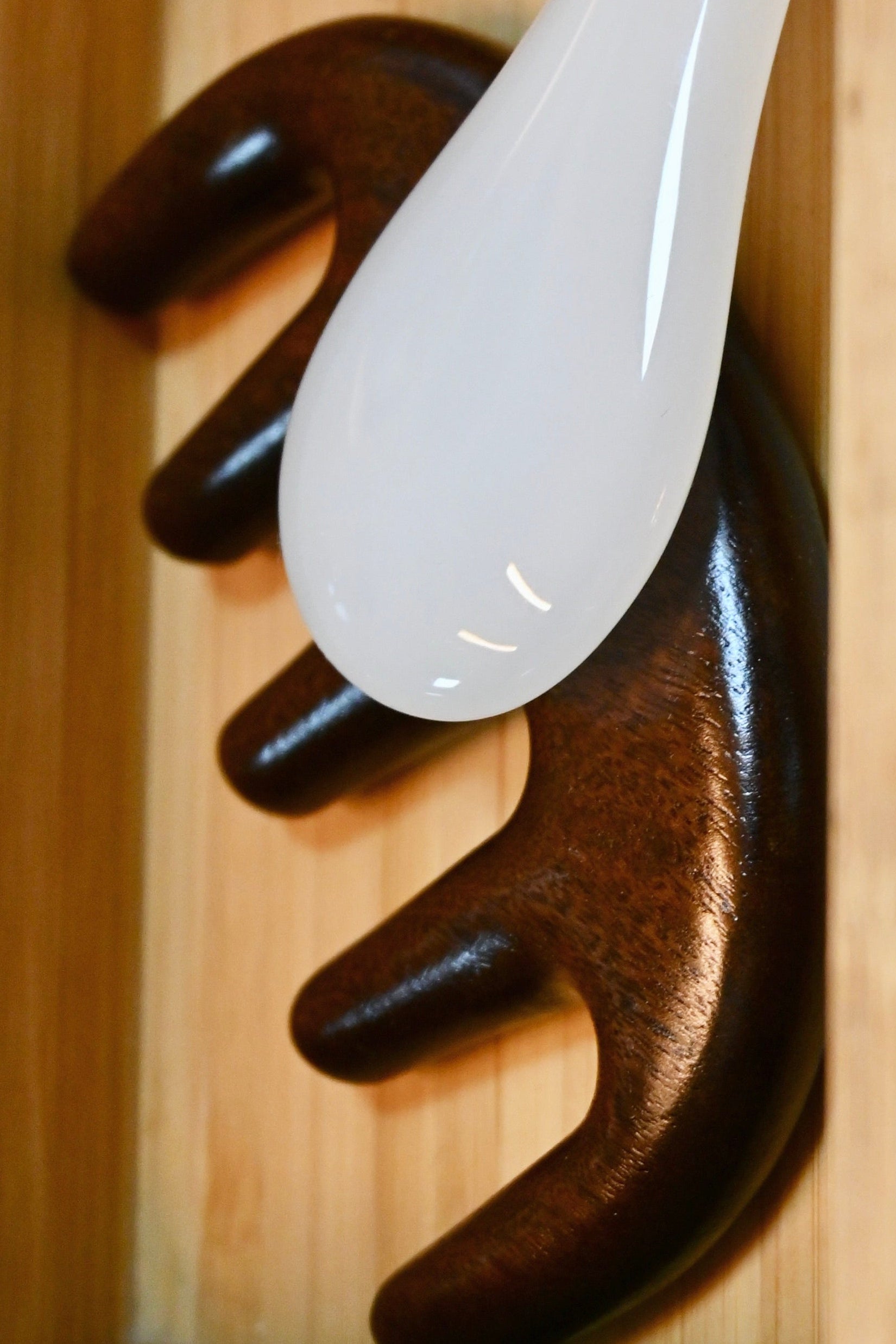 Wooden Massager next to gua sha