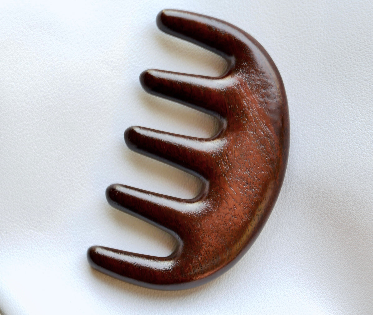 Front view of a wooden scalp massager